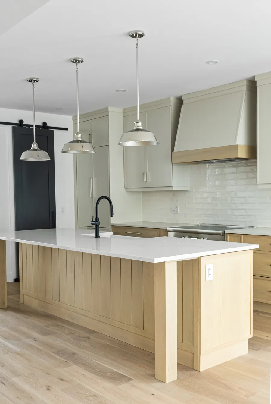 Kitchen at Dwight Beach Road with a white oak island and sage cabinetry