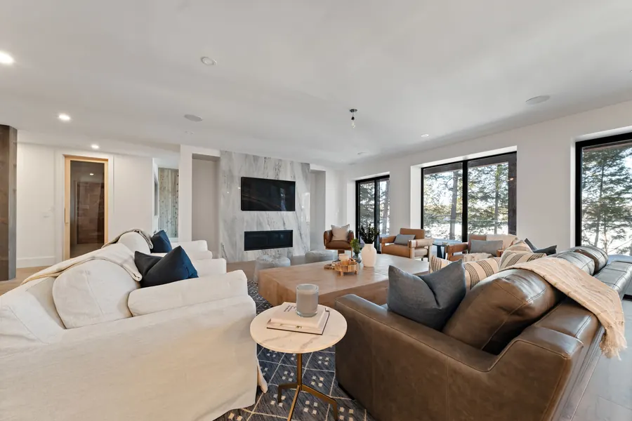 Great room at Hemlock Point with lake views and a stone fireplace